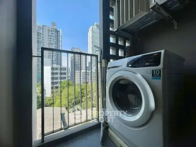 Modern condo balcony with washing machine and city view