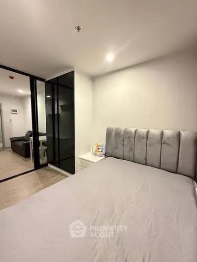 Modern bedroom with sleek design and cozy ambiance in a contemporary apartment.