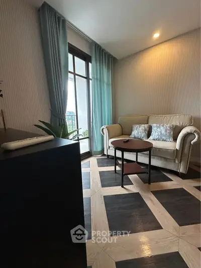 Chic living room with elegant sofa, stylish flooring, and large window for natural light.