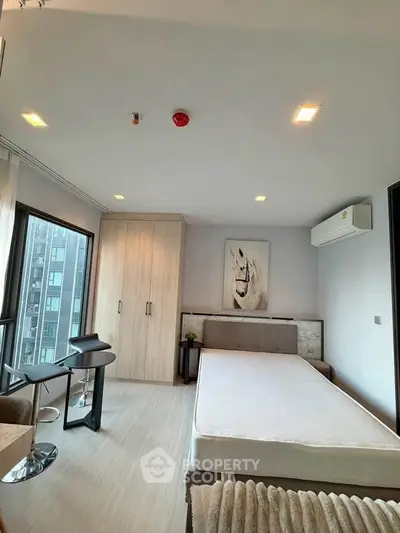 Modern bedroom with large windows and stylish decor in urban apartment