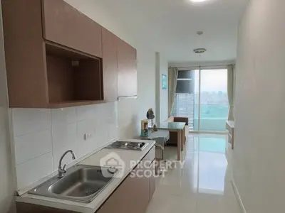 Modern kitchen with sleek cabinetry and city view from window