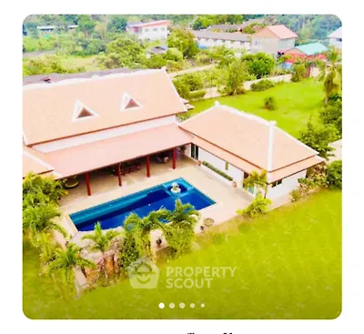 Stunning aerial view of luxury villa with private pool and lush garden
