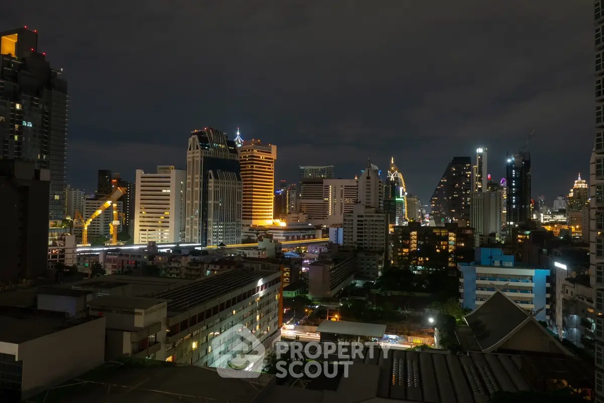 Stunning cityscape view of illuminated skyscrapers at night, showcasing urban living.
