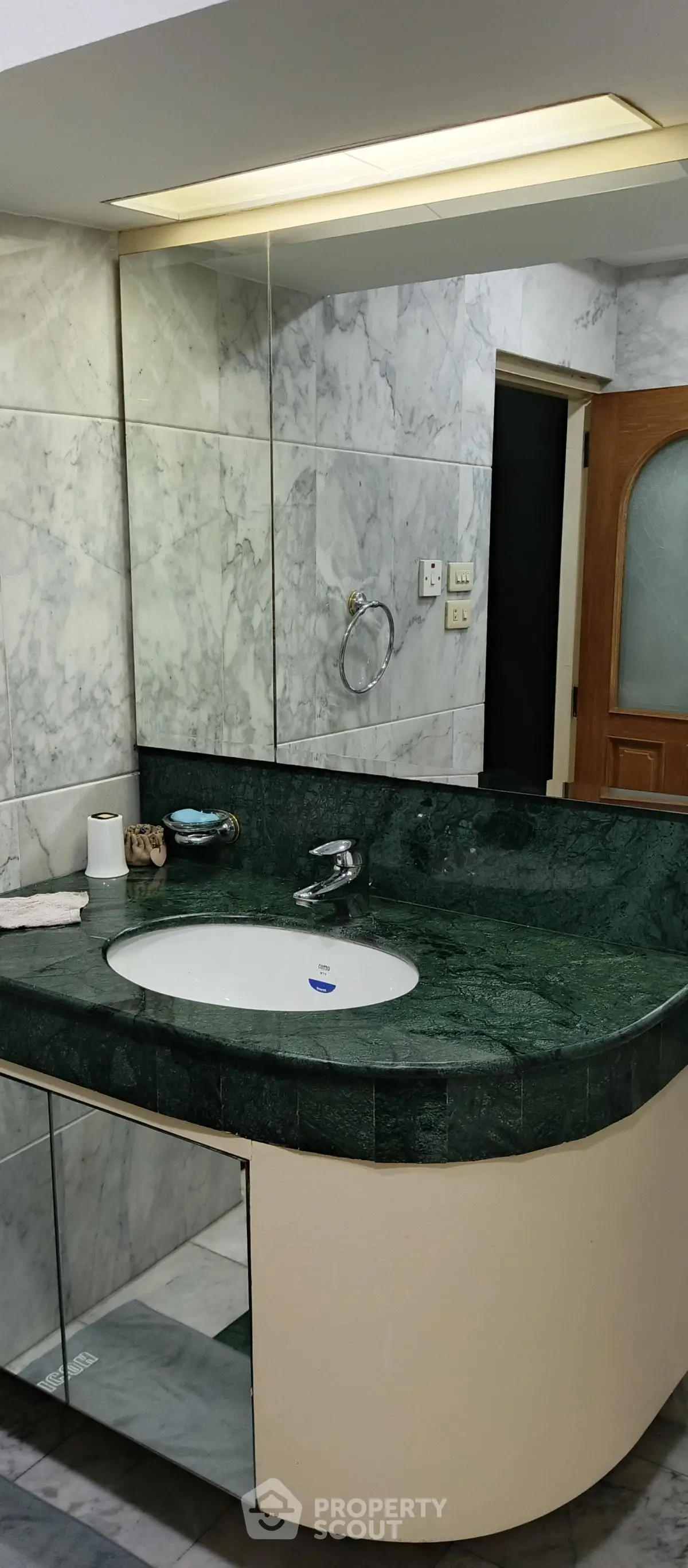 Luxurious marble bathroom with elegant green countertop and modern fixtures