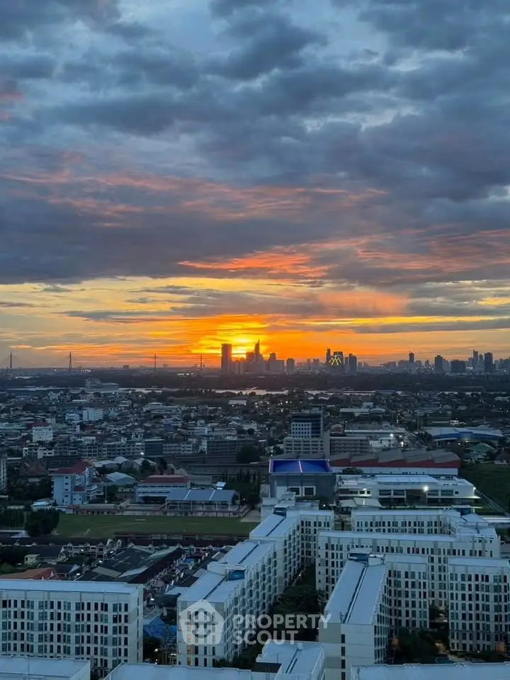 Stunning cityscape view at sunset with vibrant sky over urban skyline.