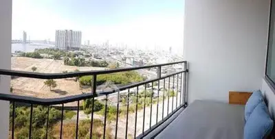 Spacious balcony with stunning city and river views, perfect for relaxation.