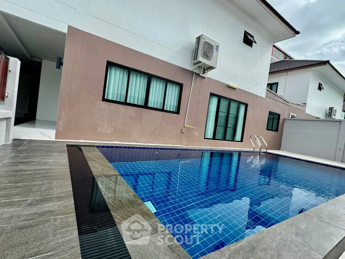 Modern residential property with private swimming pool and sleek exterior design.