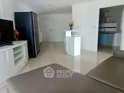 Spacious modern living room with sleek furniture and open kitchen layout, perfect for contemporary living.