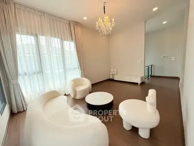Elegant living room with modern white furniture and chandelier