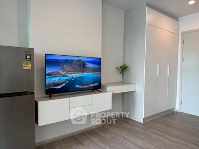 Modern living space with sleek cabinetry and flat-screen TV, perfect for contemporary living.