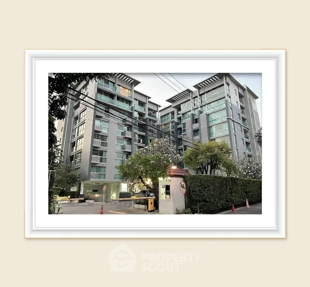 Modern apartment building exterior with lush greenery and secure entrance