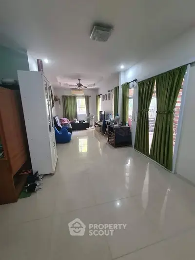 Spacious living room with elegant decor and large windows for natural light.