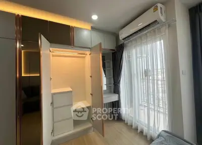 Modern bedroom with open wardrobe and balcony view, featuring sleek design and ample natural light.