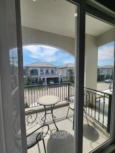 Charming balcony view with elegant outdoor furniture and scenic neighborhood