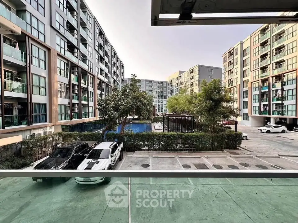 Modern apartment complex with parking and pool view