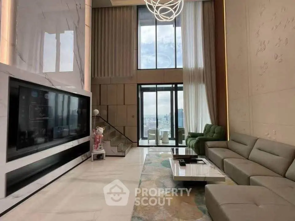 Luxurious modern living room with high ceilings and large windows offering stunning city views.