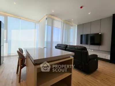 Modern living room with sleek furniture and panoramic windows offering stunning views.
