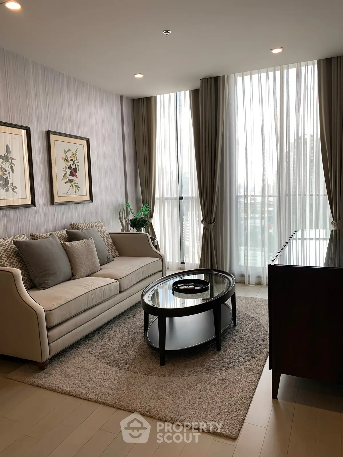 Elegant living room with modern decor and large windows offering city views.