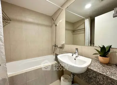 Modern bathroom with bathtub and sleek sink in a stylish apartment.