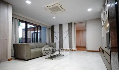 Modern living room with sleek design and large windows for natural light.