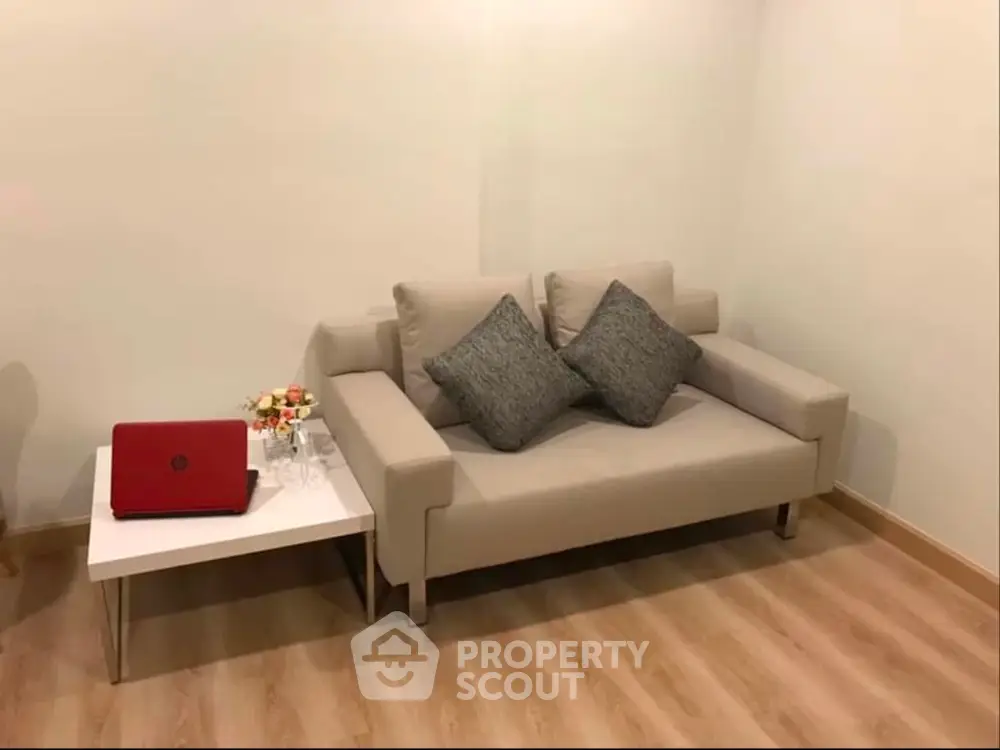 Cozy living room with modern beige sofa and stylish side table