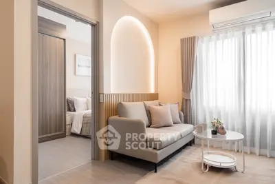 Modern living room with cozy sofa and natural light, adjacent to a stylish bedroom.