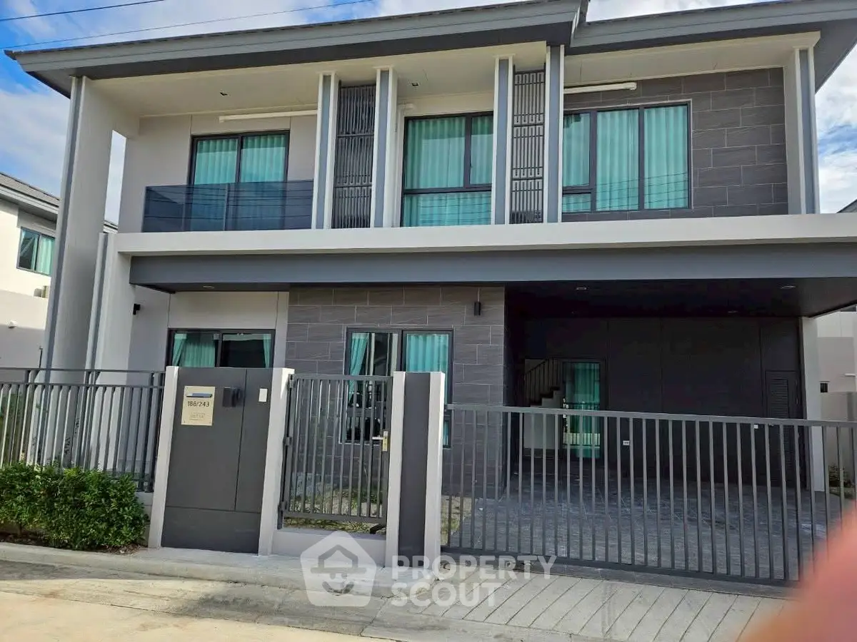 Modern two-story house with sleek design and gated entrance