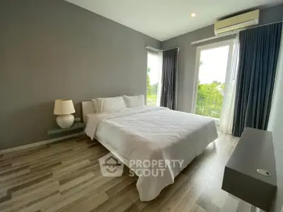 Modern bedroom with large window and stylish decor