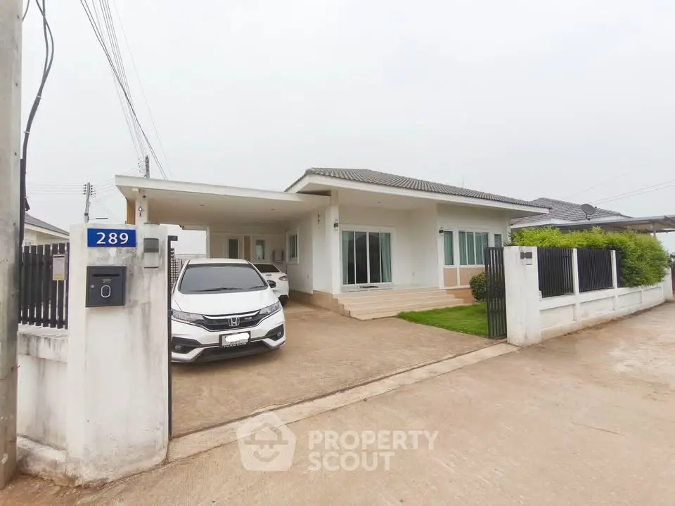 Charming single-story home with driveway and modern exterior design, perfect for family living.