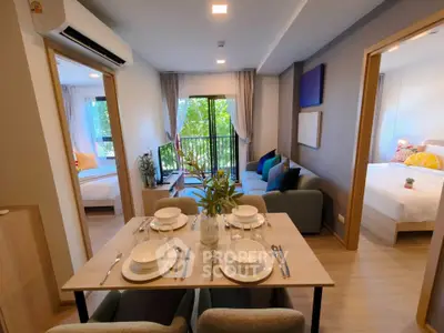 Modern open-plan living and dining area with natural light and stylish decor