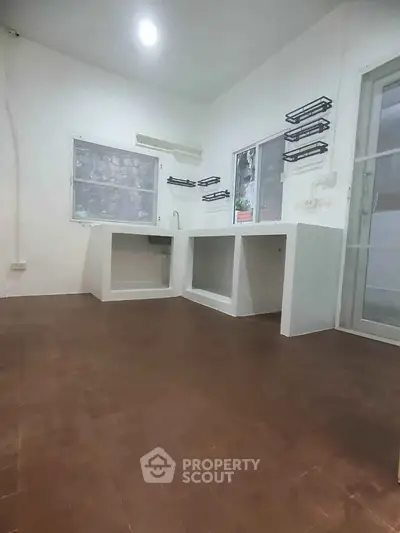 Spacious kitchen with open layout and modern design, featuring ample counter space and natural light.