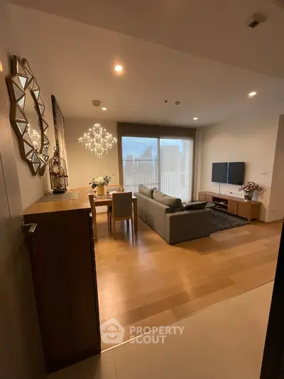 Modern living room with elegant decor, spacious seating, and large windows offering natural light.