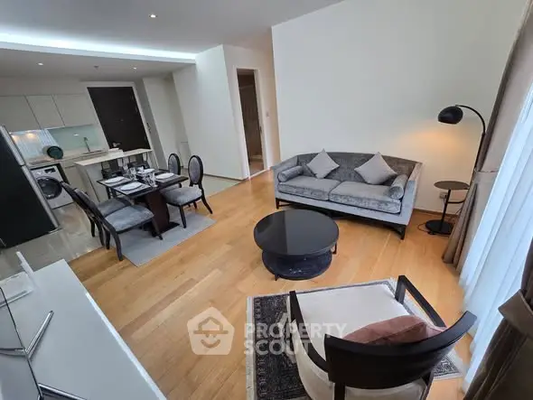 Spacious modern living room with elegant furniture and open kitchen layout