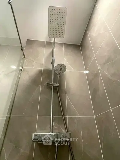 Modern bathroom shower with sleek design and dual shower heads in a stylish tiled setting.