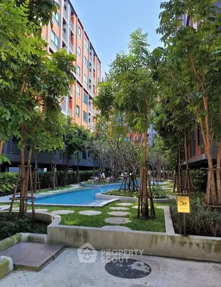 Modern residential complex with lush garden and swimming pool