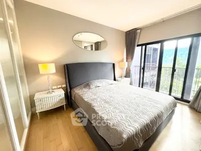 Spacious bedroom with elegant decor and large windows offering natural light.