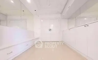 Spacious white hallway with modern cabinetry and sleek design