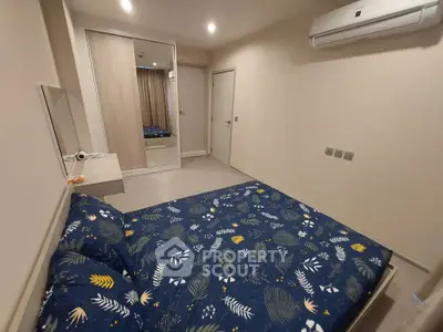 Modern bedroom with stylish decor and mirrored wardrobe