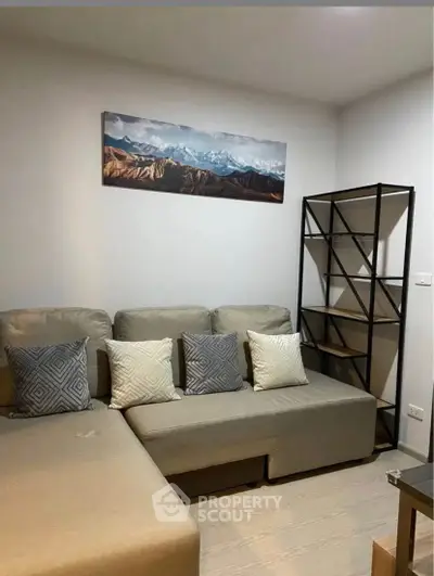 Cozy living room with modern sofa and stylish shelving unit.