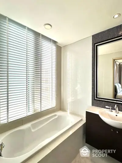 Modern bathroom with sleek bathtub and stylish vanity mirror