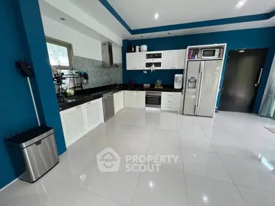 Modern kitchen with sleek appliances and open layout in stylish home