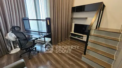 Modern study room with sleek desk, ergonomic chair, and stylish staircase