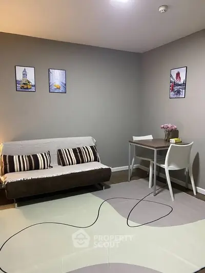 Cozy living room with modern decor and dining area in a stylish apartment.