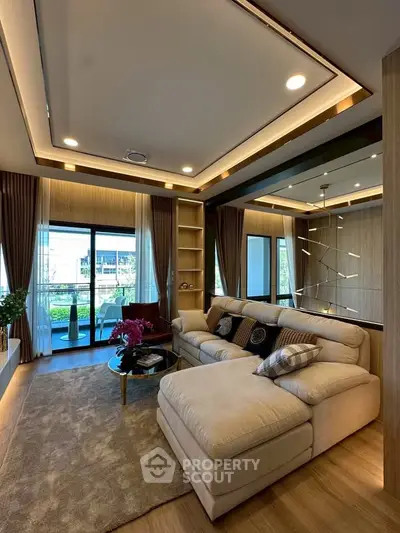 Luxurious living room with modern decor and large windows opening to a balcony with a view.