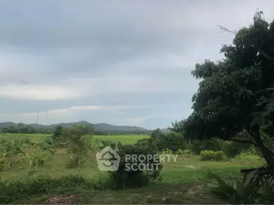 Scenic rural landscape with lush greenery and distant mountains, perfect for serene living or agricultural investment.