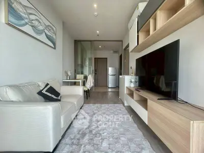 Modern living room with sleek furniture and large TV, perfect for relaxation.