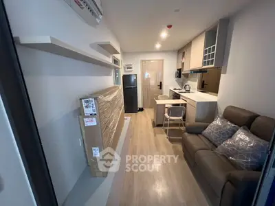 Modern compact living room with sleek kitchen and cozy seating area