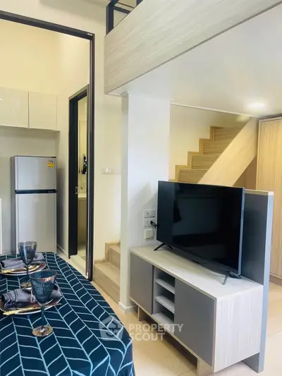 Modern loft-style apartment with sleek kitchen and stylish living area, perfect for urban living.
