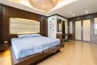 Luxurious modern bedroom with stylish wooden accents and ambient lighting