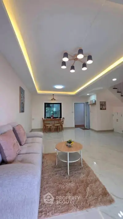 Spacious modern living room with elegant lighting and cozy seating area